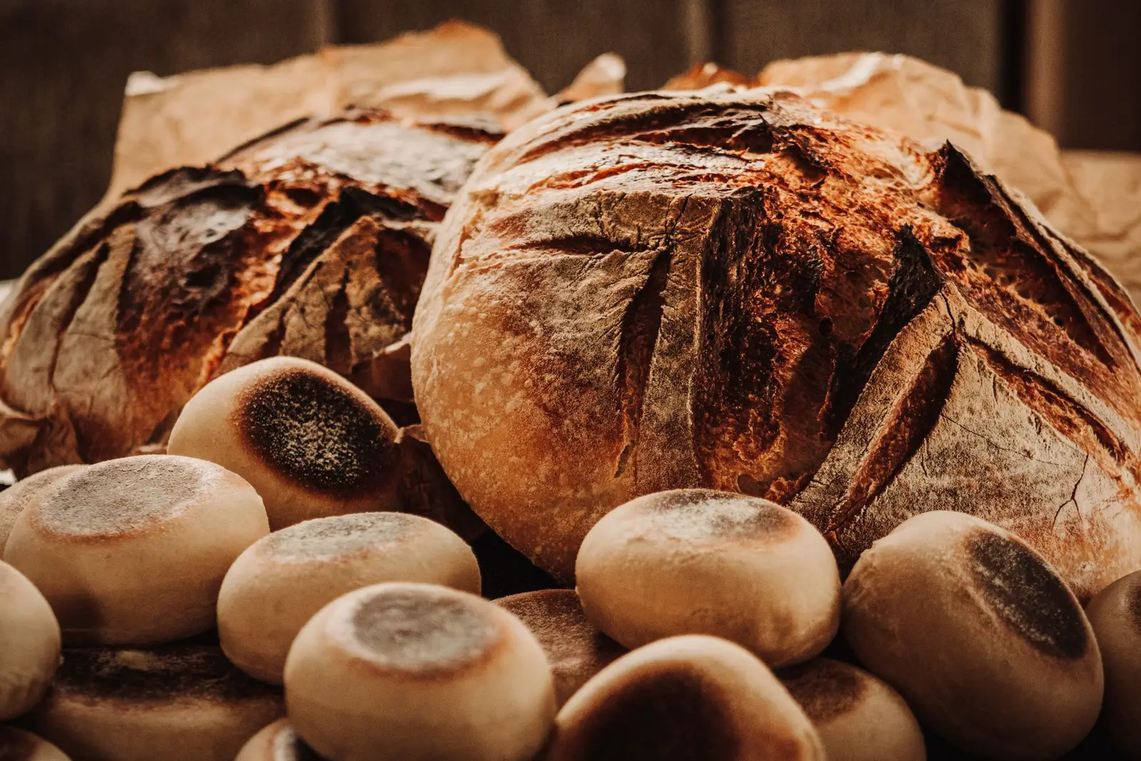 Golden baked sourdough rolls on a rack
